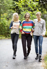 Three generation females walking on street