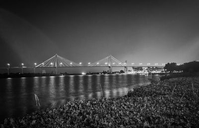 Bridge over calm river at night