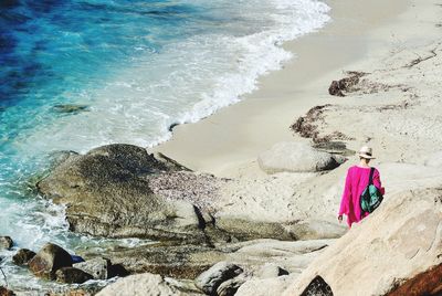 Rear view of woman standing on beach