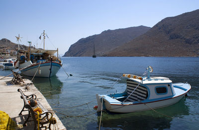 Boats moored at shore against clear sky