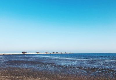 Scenic view of sea against clear blue sky