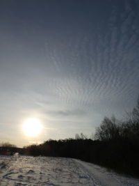 Scenic view of snow covered landscape against sky during sunset
