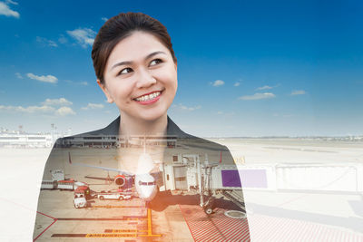 Digital composite image of thoughtful woman and airport