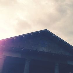 Low angle view of building against cloudy sky