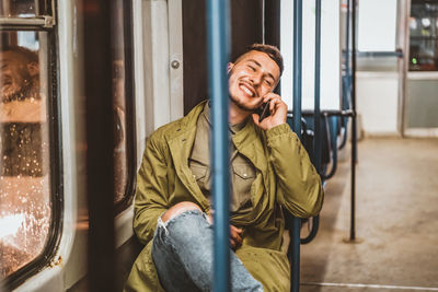 People, lifestyle, travel and public transport. man looking at the phone while sitting in public bus