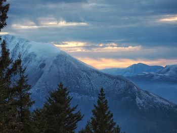 Scenic view of snowcapped mountains against sky during sunset