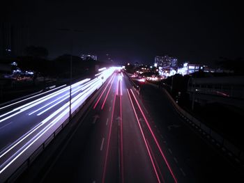 High angle view of light trails on highway at night