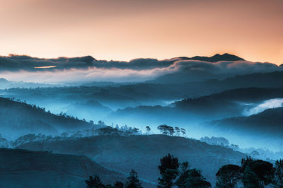 Glorious scenic view of mountains against sky during sunrise