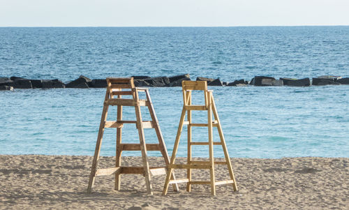 Lifeguard hut on beach against clear sky