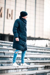 Full length side view of a man in snow