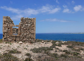 Castle by sea against sky