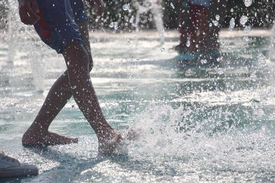 Low section of man running on water