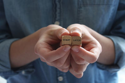 Midsection of man holding text