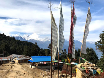 Built structure against trees and mountains against sky