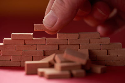 Cropped hand holding toy blocks