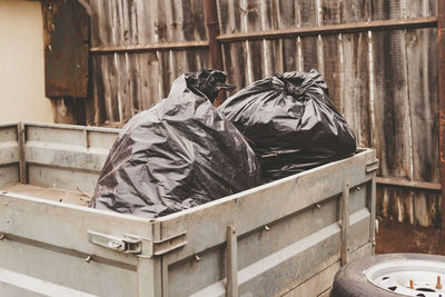 Bags with garbage in the trailer, cleaning the territory, garden. 