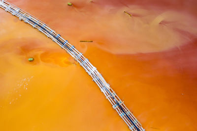 Aerial view of colorful red polluted mine water from copper open pit excavation in geamana, romania