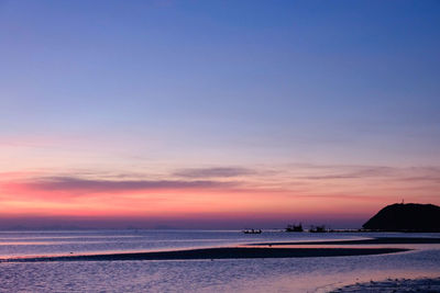 Scenic view of beach against sky during sunset