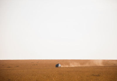 Tractor on field against sky