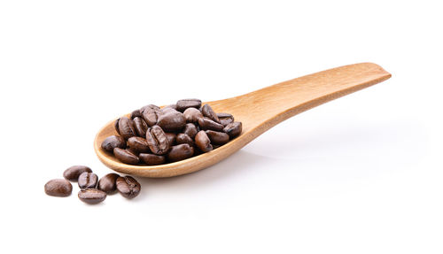 Close-up of coffee beans against white background