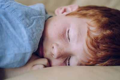 Close-up of boy sleeping on sofa