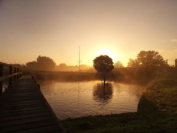 Scenic view of river at sunset