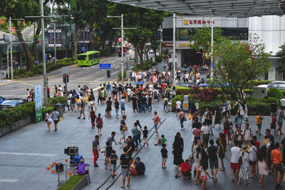 Group of people walking on road in city