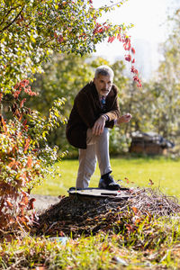 Portrait of young man sitting on field