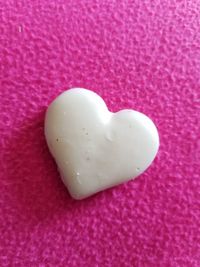 High angle view of heart shape on pink cake