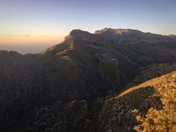 Scenic view of mountains against clear sky during sunset