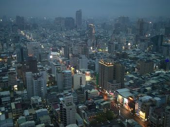 High angle view of illuminated city buildings at night