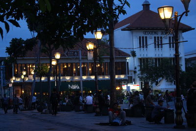 Group of people in illuminated building at night