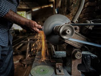 Midsection of man working in factory