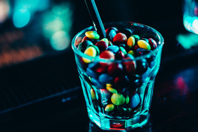 Close-up of colorful candies in drinking glass on table