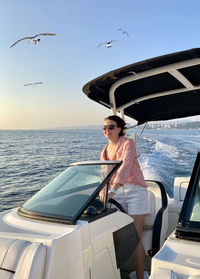 Rear view of woman in boat in sea