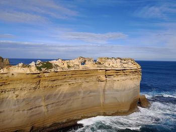 Rock formations in sea against sky