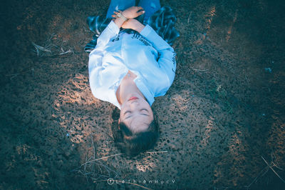 High angle view of woman relaxing on field