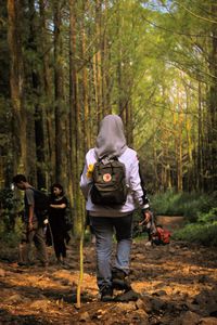 Full length of people walking in forest