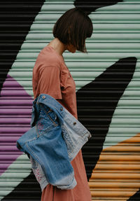 Midsection of woman with umbrella walking on staircase