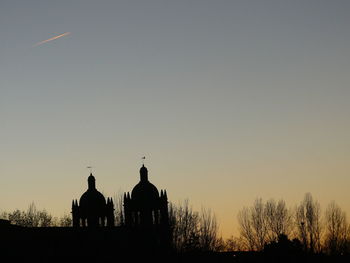 Silhouette building against clear sky during sunset