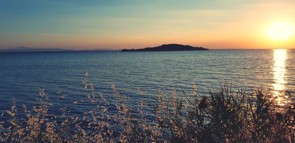 Scenic view of sea against sky during sunset