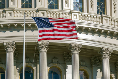 Low angle view of flags against building