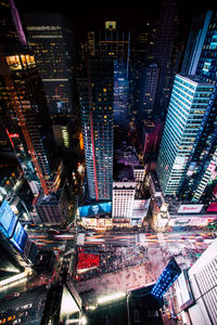 High angle view of city lit up at night