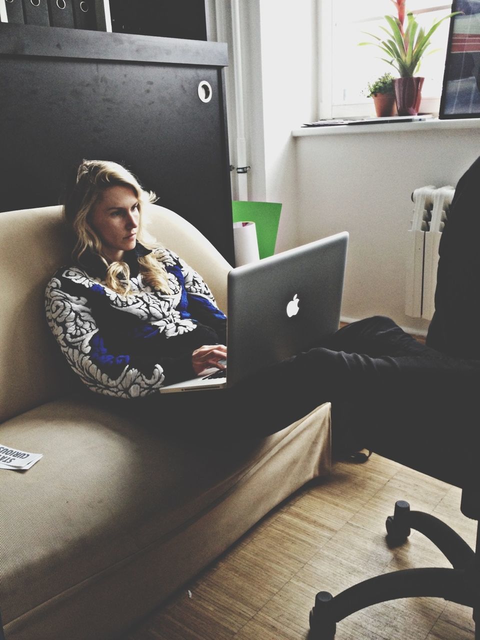 indoors, sitting, home interior, relaxation, person, young adult, bed, chair, lifestyles, sofa, living room, domestic room, table, leisure activity, casual clothing, domestic life, young women, looking at camera