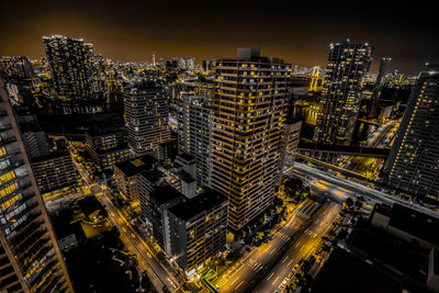 High angle view of illuminated buildings in city at night