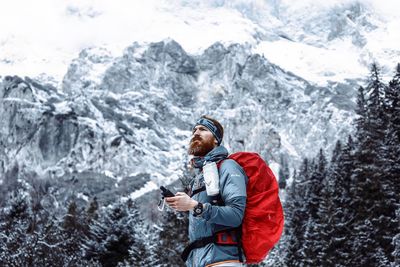 Man standing on snow covered mountain