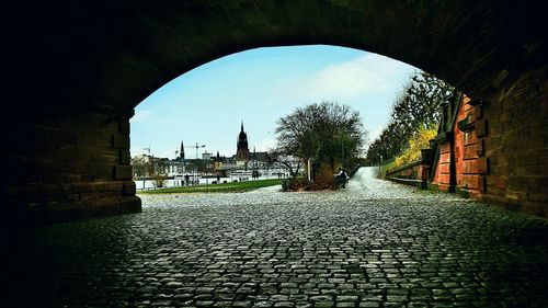 Arch bridge in front of built structure