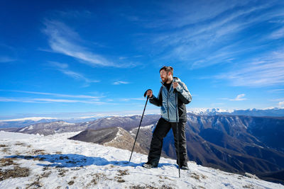 Rear view of man skiing on snow covered mountain