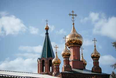 Close-up.russian christian orthodox church with golden domes and a cross against the sky .the