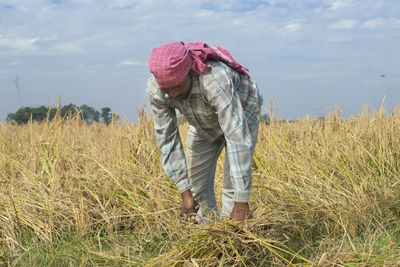 Full length of indian farmer working in field